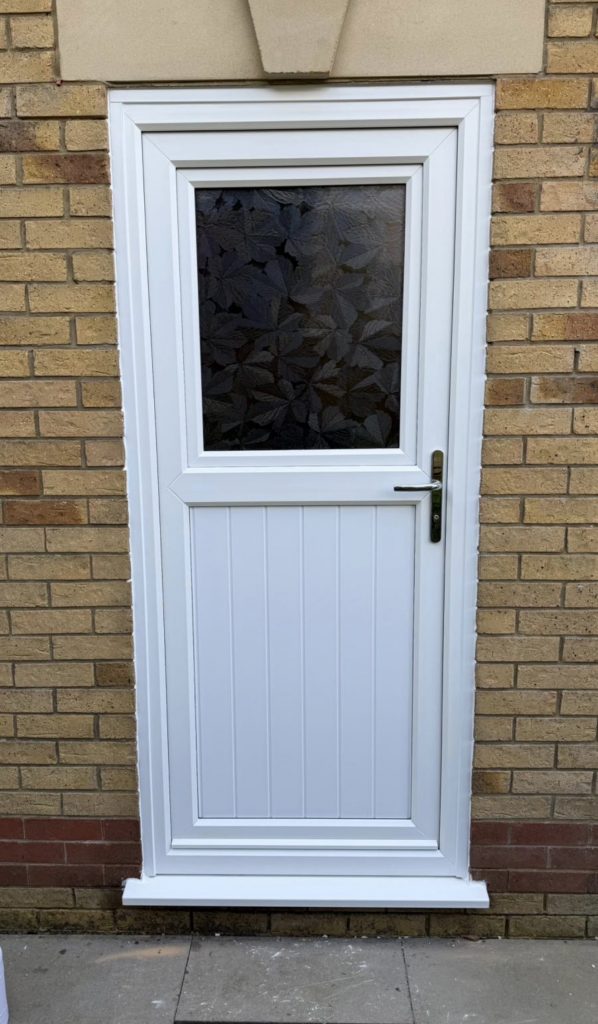 Secure white uPVC door with decorative glass – installed in Ammanford by Lion Guard